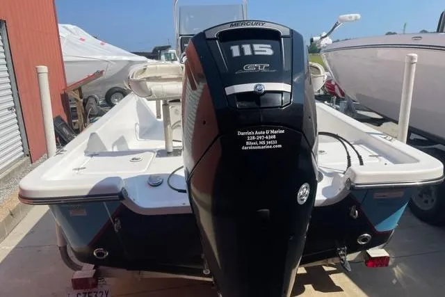 Slide: The Image of Blazer Bay 1960 boat, 2016 model, with Mercury 115 outboard motor, parked outdoors. - 8