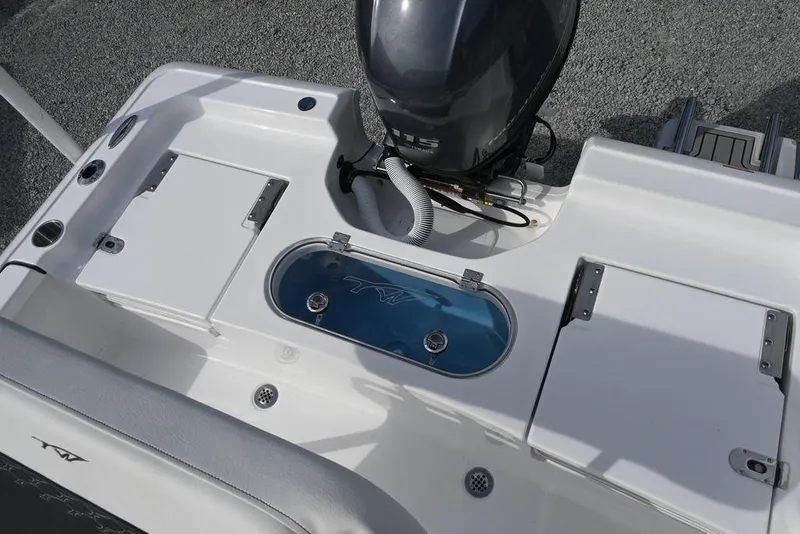 Slide: The Image of 2026 Tidewater 1910 Bay Max boat deck with motor and storage compartments. - 11