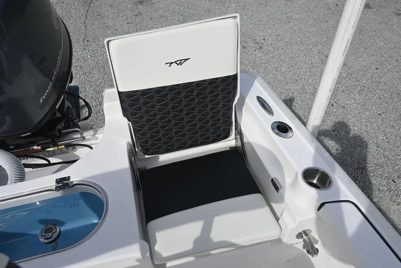 Slide: The Image of 2026 Tidewater 1910 Bay Max boat seat with black and white design, featuring cup holders. - 13