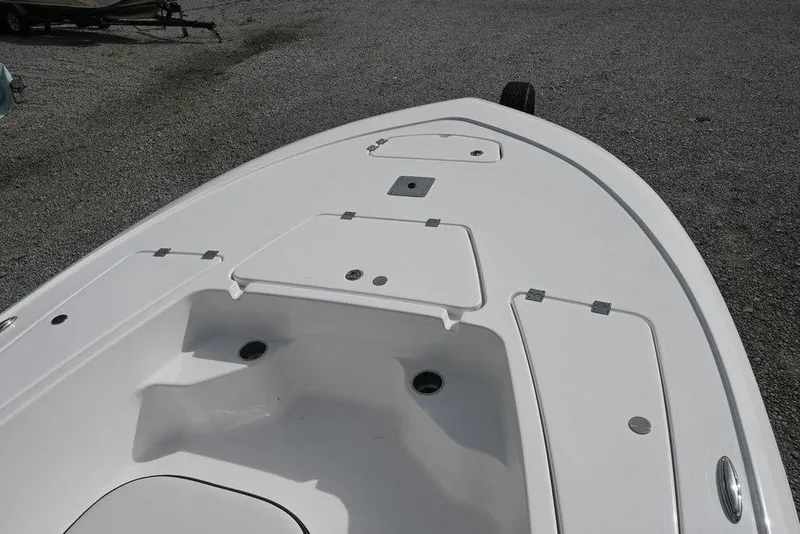 Slide: The Image of 2026 Tidewater 1910 Bay Max boat deck with storage compartments, shown on gravel surface. - 4