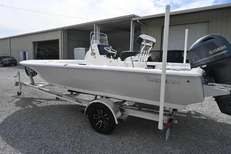 Slide: The Image of 2026 Tidewater 1910 Bay Max boat on trailer, parked outside a warehouse. - 6