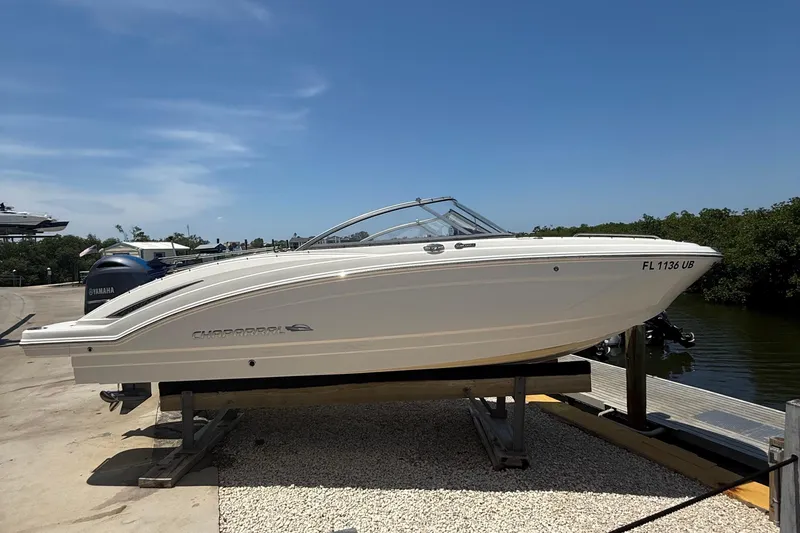 The Image of 2016 Chaparral 230 Suncoast boat on dock, side view, clear sky background. - 1