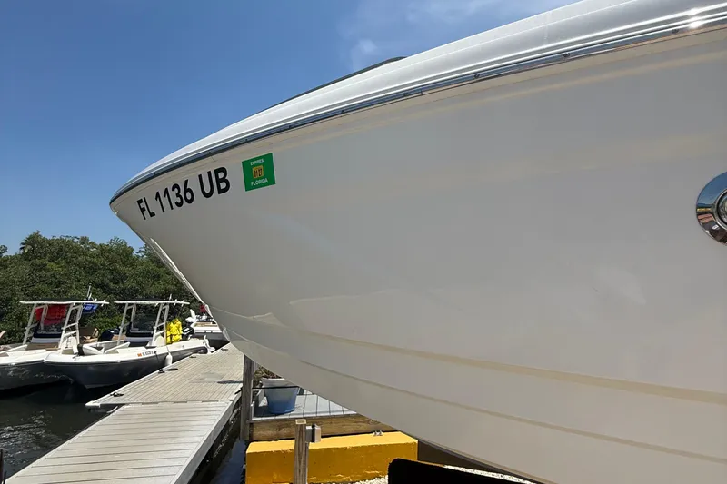 Slide: The Image of 2016 Chaparral 230 Suncoast boat docked, displaying registration FL 1136 UB. - 12