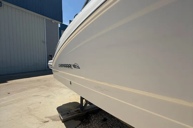 Slide: The Image of 2016 Chaparral 230 Suncoast boat side view, docked outdoors. - 13