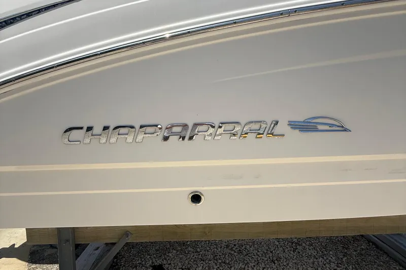 Slide: The Image of 2016 Chaparral 230 Suncoast boat logo on white hull. - 14