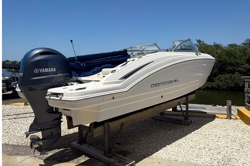 Slide: The Image of 2016 Chaparral 230 Suncoast boat with Yamaha engine on display outdoors. - 2