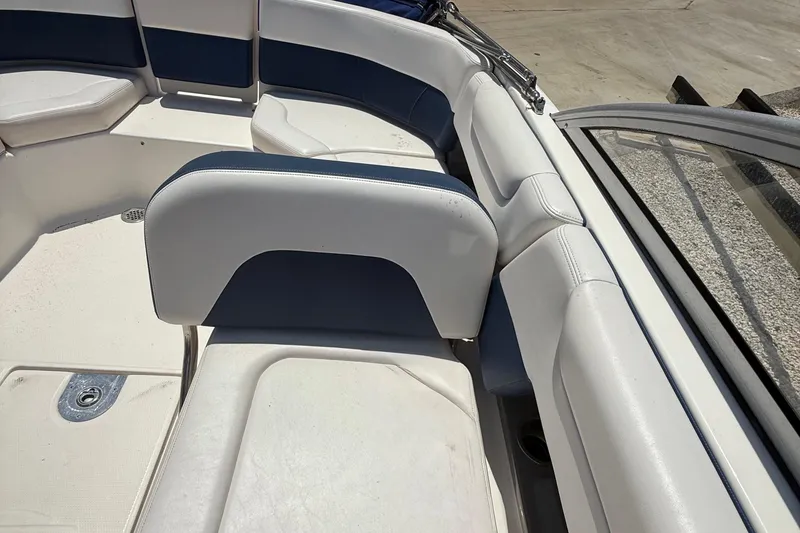 Slide: The Image of 2016 Chaparral 230 Suncoast boat interior with white and blue seating. - 25