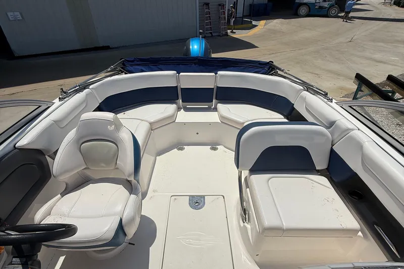 Slide: The Image of 2016 Chaparral 230 Suncoast boat interior with white and blue seating arrangement. - 26