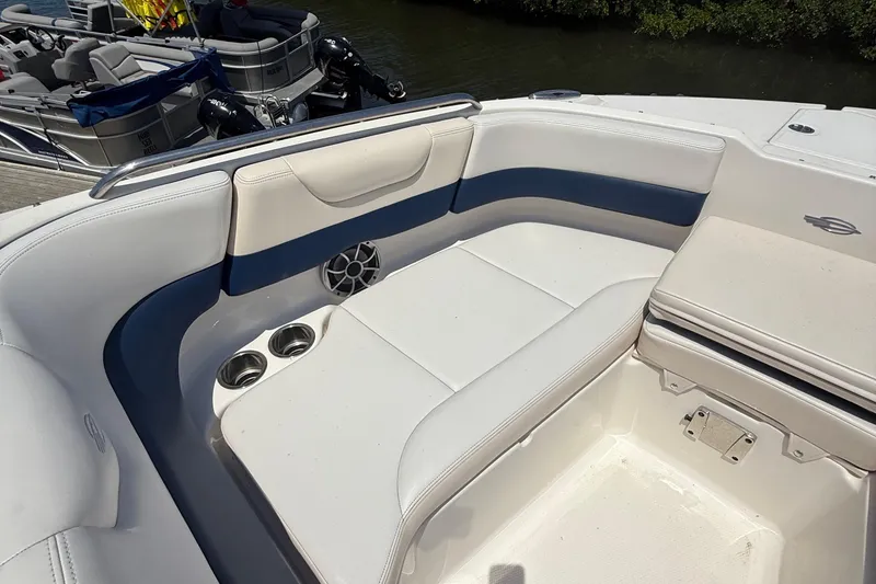 Slide: The Image of 2016 Chaparral 230 Suncoast boat interior with white and blue seating. - 28