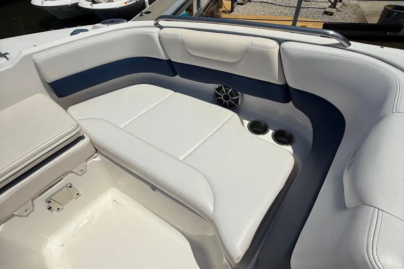 Slide: The Image of 2016 Chaparral 230 Suncoast boat interior with white and blue seating. - 29
