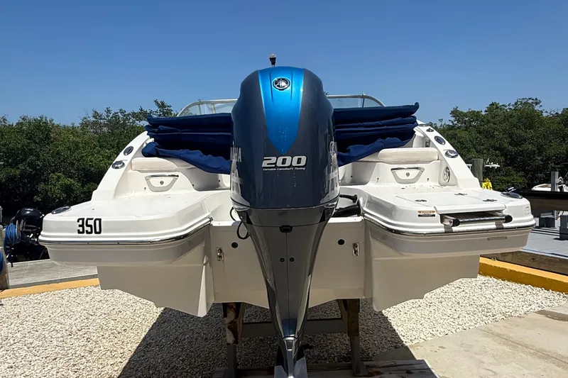 Slide: The Image of 2016 Chaparral 230 Suncoast boat with Yamaha 200 engine, docked outdoors. - 3