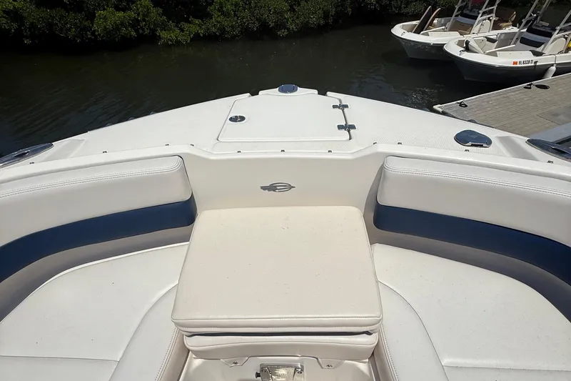 Slide: The Image of 2016 Chaparral 230 Suncoast boat interior with cushioned seating and sleek design. - 30