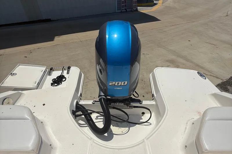 Slide: The Image of 2016 Chaparral 230 Suncoast boat with Yamaha 200 engine, docked on concrete. - 33