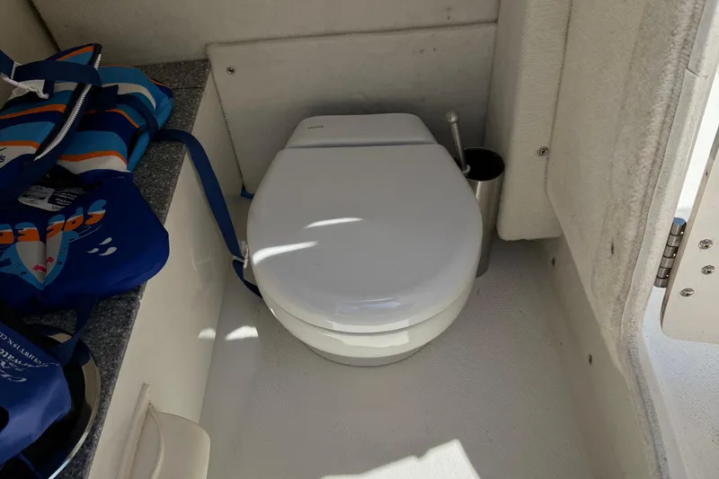 Slide: The Image of 2016 Chaparral 230 Suncoast boat interior with toilet and life jackets. - 34