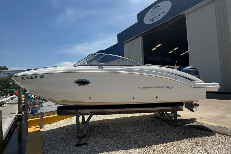 Slide: The Image of 2016 Chaparral 230 Suncoast boat on display at marina under clear blue sky. - 4