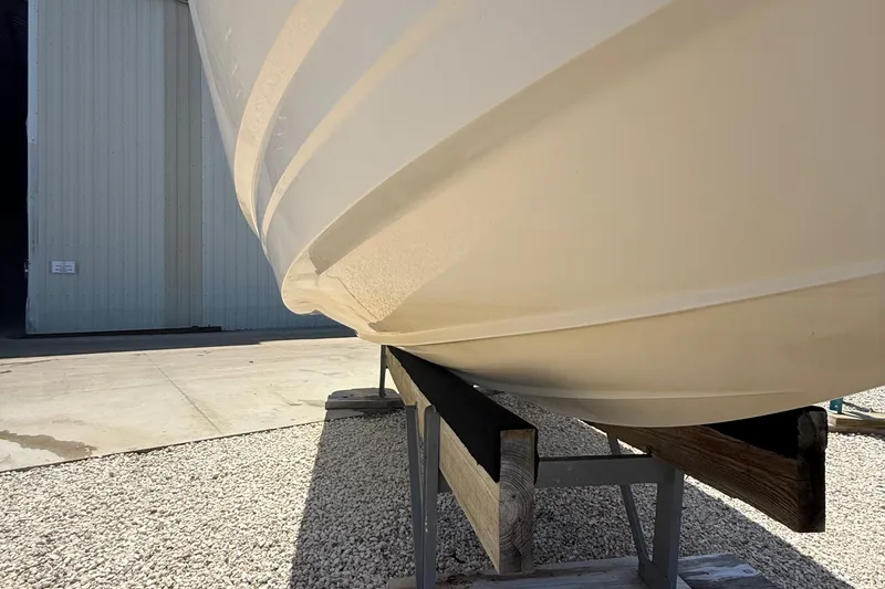 Slide: The Image of 2016 Chaparral 230 Suncoast boat hull on a trailer near a warehouse. - 8
