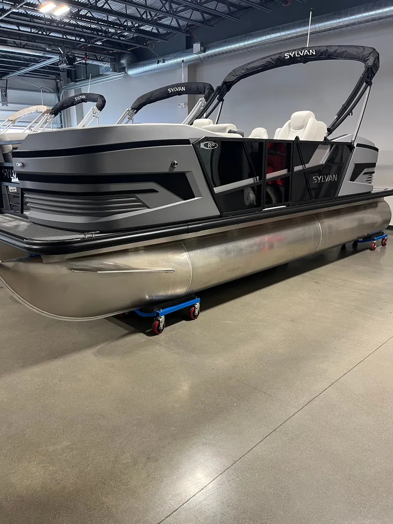The Image of 2026 Sylvan R-20 PARTY FISH pontoon boat in a showroom. - 0