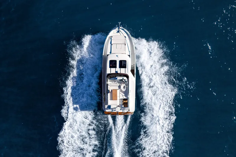 Slide: The Image of Aerial view of 2026 Beneteau Swift Trawler 37 cruising on open water. - 13