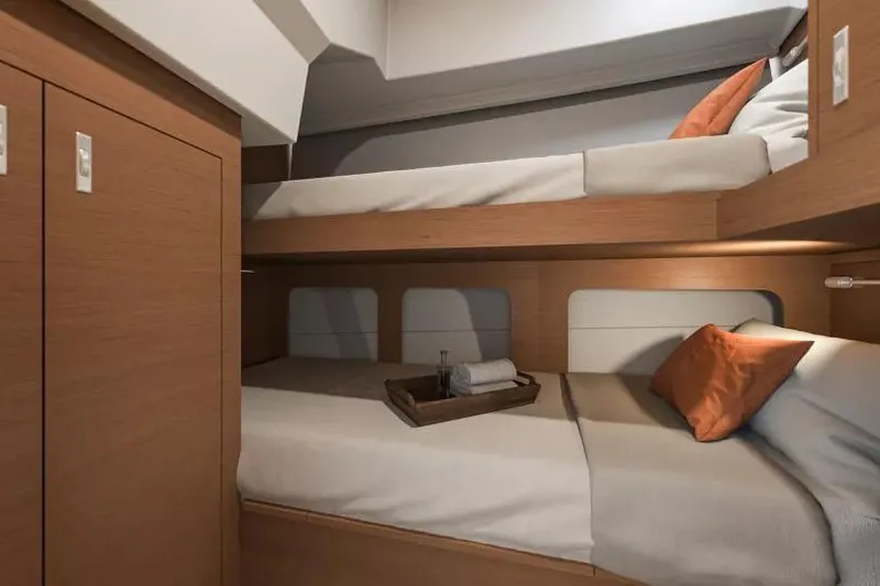 Slide: The Image of 2026 Beneteau Swift Trawler 37 cabin with cozy bunk beds and wooden interior. - 20