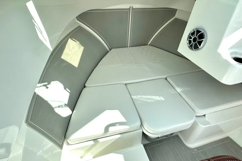 Slide: The Image of 2025 Parker 2420 Sport Cabin interior with cushioned seating and speaker. - 5