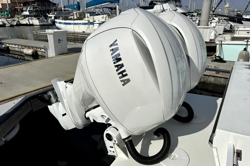 Slide: The Image of Twin Yamaha outboard motors on a 2025 Parker 247 Explorer at a marina. - 9