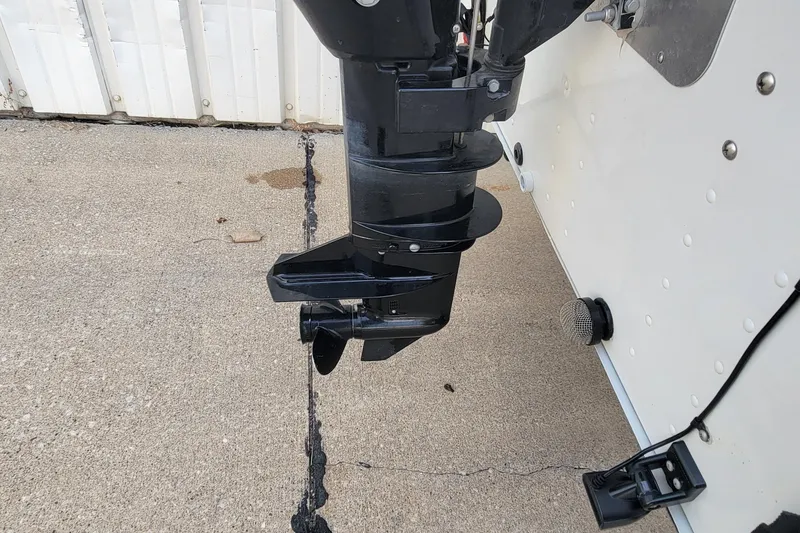 Slide: The Image of Outboard motor of a 2014 MirroCraft 1400 boat on concrete surface. - 15