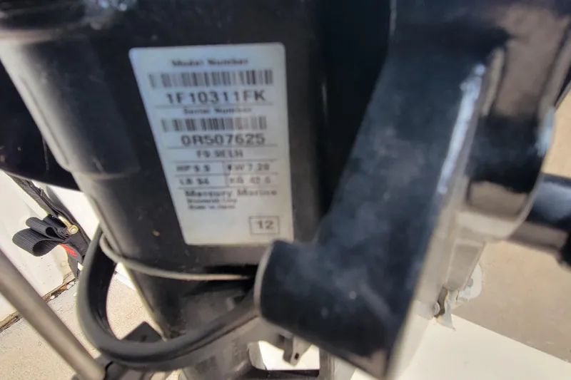 Slide: The Image of Close-up of a Mercury Marine engine label on a 2014 MirroCraft 1400 boat. - 17