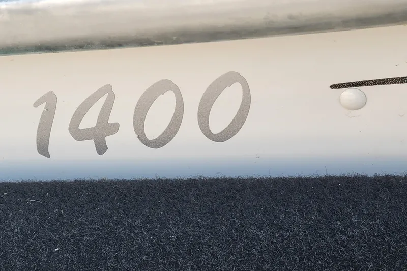 Slide: The Image of Close-up of 2014 MirroCraft 1400 boat model number on hull. - 5