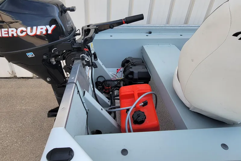 Slide: The Image of 2014 MirroCraft 1400 boat interior with Mercury outboard motor and red fuel tank. - 6