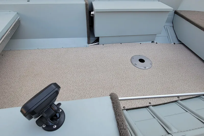 Slide: The Image of Interior of 2014 MirroCraft 1400 boat showing seating and deck details. - 7