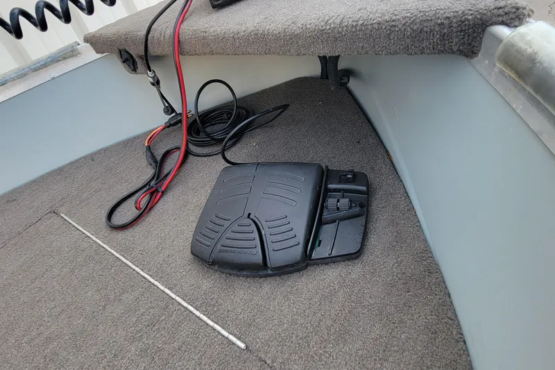 Slide: The Image of Foot pedal and cables on a 2014 MirroCraft 1400 boat's carpeted floor. - 8