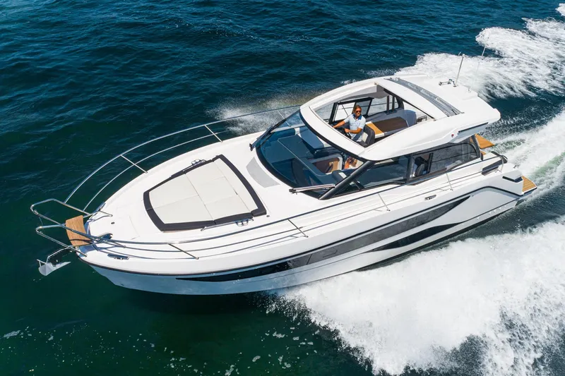 Slide: The Image of 2024 Bavaria SR38 yacht cruising on open water, showcasing sleek design and luxury features. - 13