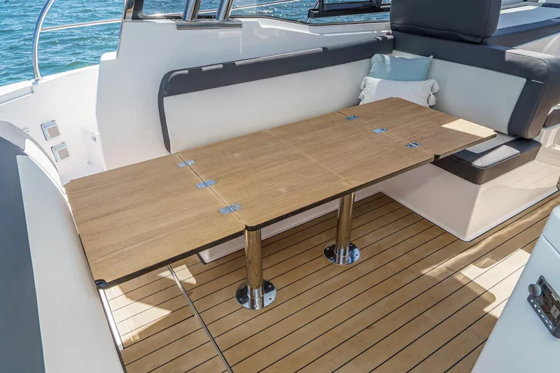 Slide: The Image of 2024 Bavaria SR38 yacht interior with wooden table and cushioned seating. - 22