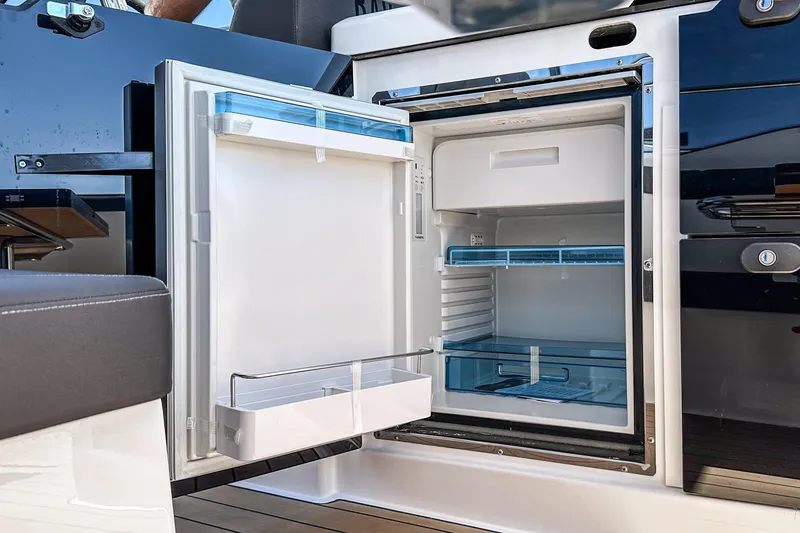 Slide: The Image of Open refrigerator on Bavaria SR38 yacht, showcasing modern interior design, 2024 model. - 25