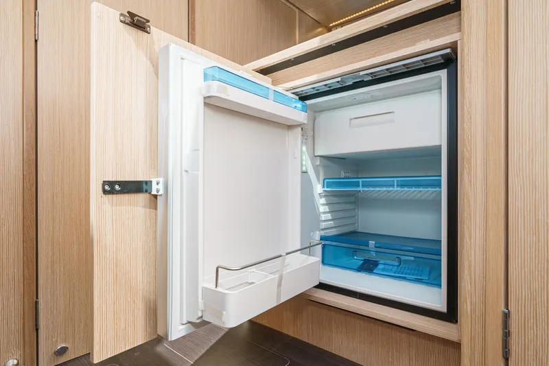 Slide: The Image of Open refrigerator in Bavaria SR38 yacht, 2024 model, with wooden cabinetry. - 36