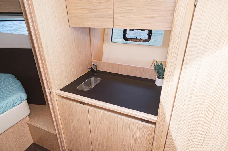 Slide: The Image of Compact kitchenette in 2024 Bavaria SR38 yacht with sink and window view. - 37