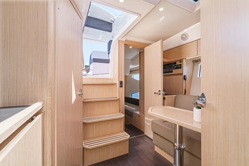 Slide: The Image of Interior of 2024 Bavaria SR38 yacht, featuring modern wood finish and cozy seating area. - 38