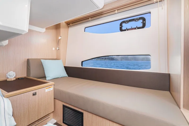 Slide: The Image of 2024 Bavaria SR38 yacht interior with cozy seating and ocean view. - 45
