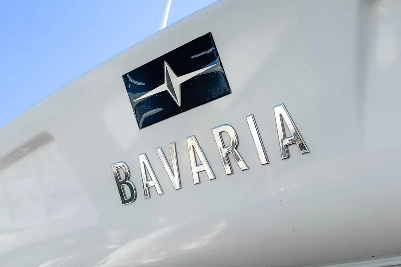 Slide: The Image of 2024 Bavaria SR38 yacht logo on white surface with blue sky background. - 49