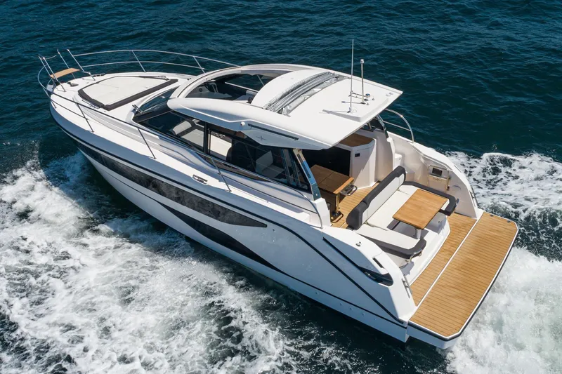 Slide: The Image of 2024 Bavaria SR38 yacht cruising on open water, showcasing sleek design and spacious deck. - 5