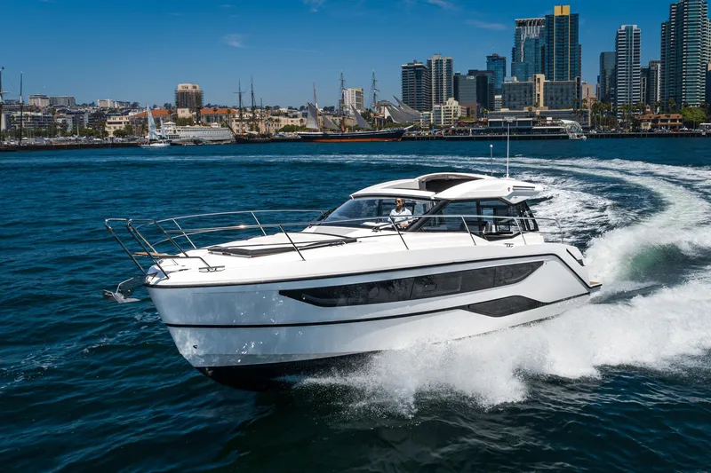 Slide: The Image of 2024 Bavaria SR38 yacht cruising in a vibrant city harbor. - 50