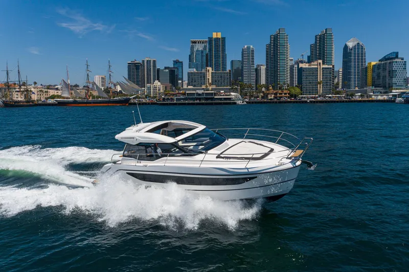 Slide: The Image of 2024 Bavaria SR38 yacht cruising near city skyline on a sunny day. - 8