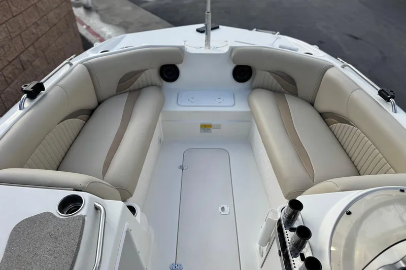 Slide: The Image of 2013 NauticStar 203 SC boat interior with beige seating and cup holders. - 12