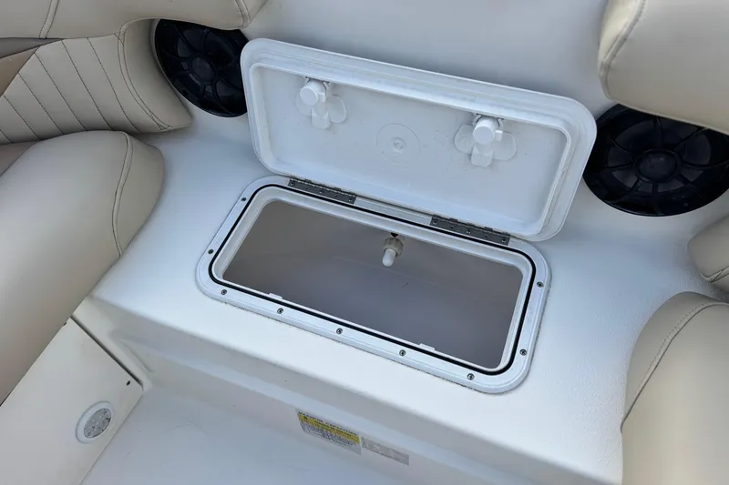 Slide: The Image of Open storage compartment on 2013 NauticStar 203 SC boat with beige seating. - 15