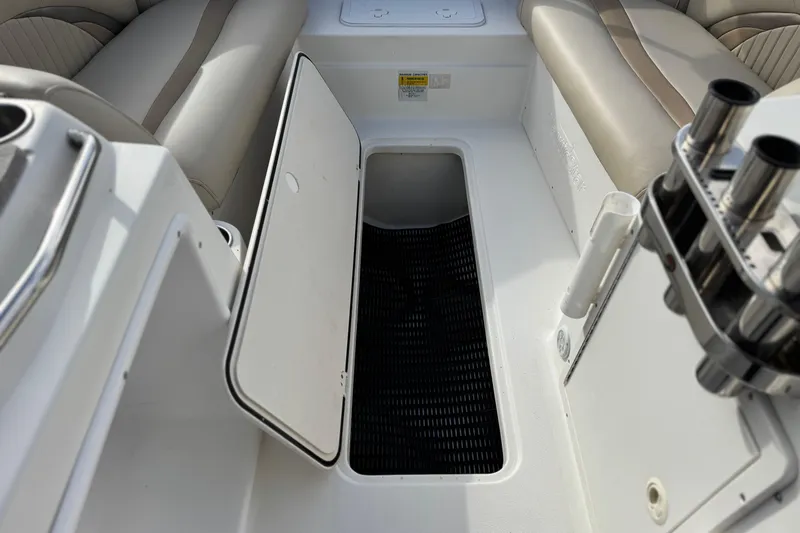 Slide: The Image of 2013 NauticStar 203 SC boat interior with open storage compartment and seating. - 18