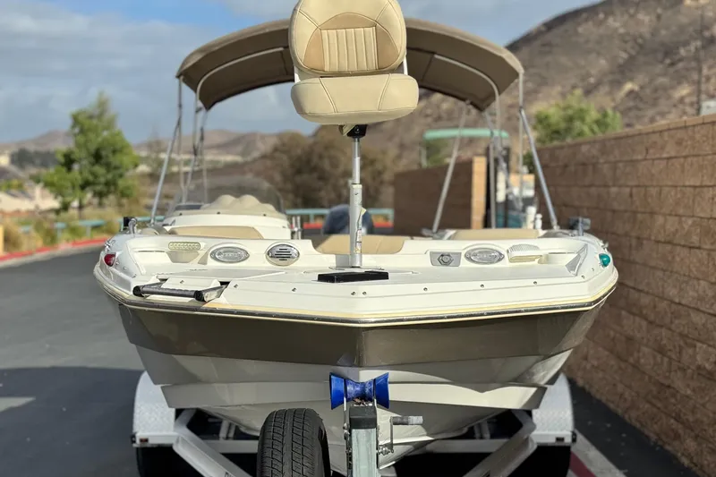 Slide: The Image of 2013 NauticStar 203 SC boat on trailer, parked outdoors with scenic background. - 2