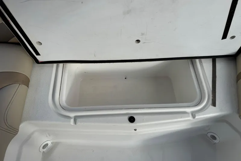 Slide: The Image of Open storage compartment on 2013 NauticStar 203 SC boat, featuring white interior. - 24