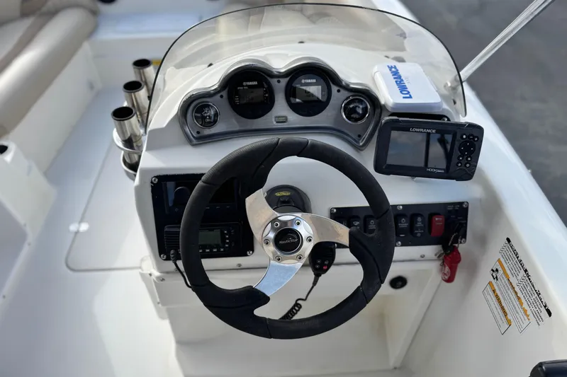 Slide: The Image of 2013 NauticStar 203 SC boat dashboard with steering wheel, gauges, and Lowrance GPS system. - 29