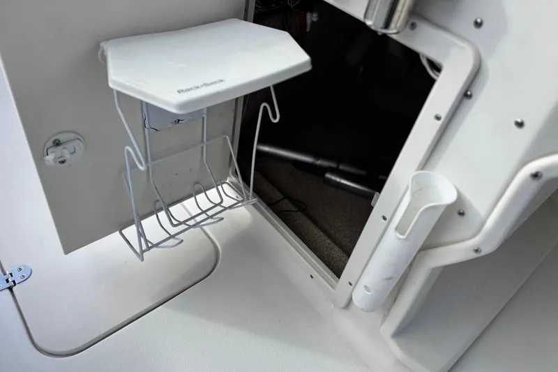 Slide: The Image of Interior view of a 2013 NauticStar 203 SC boat, featuring storage compartments. - 32