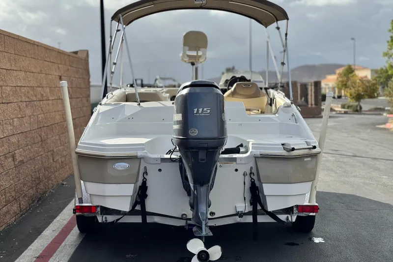 Slide: The Image of 2013 NauticStar 203 SC boat with Yamaha 115 engine, parked outdoors. - 4